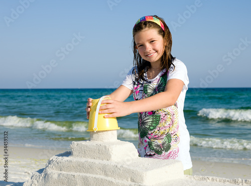 Photo: Child Building Sandcastle on a Beach Child Building Sandcastle on a Beach