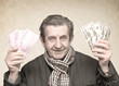 elderly happy man with pack of money