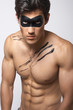 attractive young muscled man in a mask