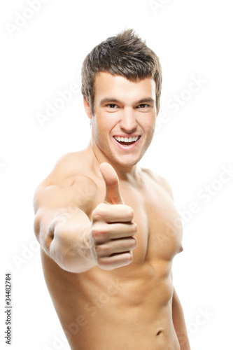 Photo: portrait of young man showimg "thumbs-up" sign portrait of young man showimg "thumbs-up" sign
