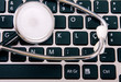 Medical stethoscope on a laptop computer, closeup