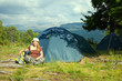 Happy hiker in front of camp tent Happy hiker in front of camp tent