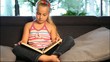 girl relaxing on the sofa and reading a book