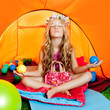 Children girl inside camping tent relaxing with yoga