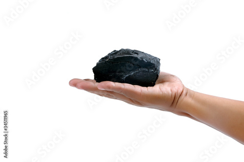 Photo: male hand holding a little lump of coal male hand holding a little lump of coal