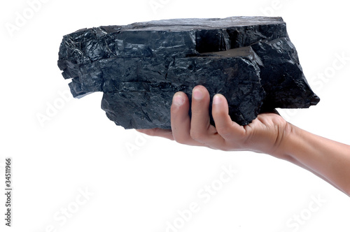 Photo: male hand holding a big lump of coal male hand holding a big lump of coal