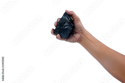 Photo: male hand holding a little lump of coal male hand holding a little lump of coal