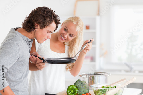 Photo: Couple cooking with a pan Couple cooking with a pan