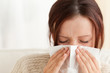 Woman blowing her nose