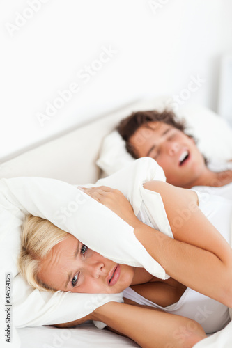 Photo: Portrait of a woman awaken by her husband's snoring Portrait of a woman awaken by her husband's snoring
