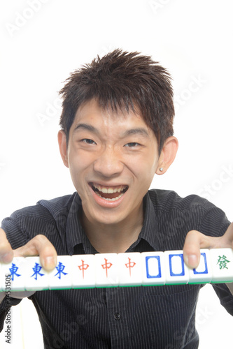 Photo: Chinese man play Mahjong, traditional China gamble. Chinese man play Mahjong, traditional China gamble.