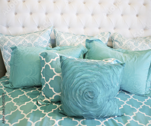 Photo: Teal colored cushions on bed Teal colored cushions on bed