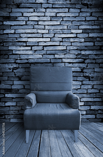 Photo: old single sofa seat in front of the wall old single sofa seat in front of the wall
