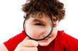 Boy looking through magnifying glass isolated on white Boy looking through magnifying glass isolated on white