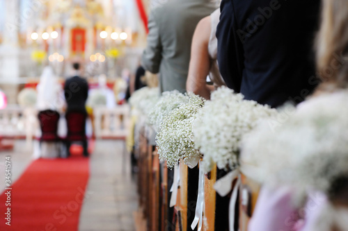 Photo: Beautiful flower wedding decoration in a church Beautiful flower wedding decoration in a church