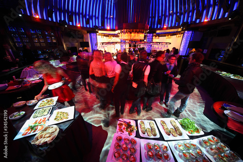 Photo: crowd of people relaxing in bar of night club crowd of people relaxing in bar of night club