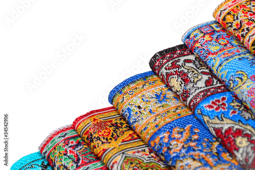 Photo: Seven bright varicoloured carpets add together in rouleau Seven bright varicoloured carpets add together in rouleau