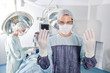 Male surgeon asking for gloves