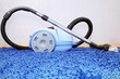 Vacuum cleaner stand  on blue carpet.