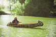 North American Indian floats down the river on a canoe