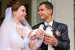Happy groom and bride holding wedding pigeons Happy groom and bride holding wedding pigeons