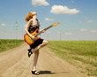 Rock girl with guitar at countryside. Rock girl with guitar at countryside.