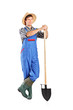 Full length portrait of a male worker holding a shovel