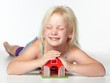 Foto: Cute little child is playing and dreaming of a new house Cute little child is playing and dreaming of a new house