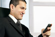 Business man reading a message on his cell phone
