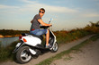 young man in glasses for driving a scooter