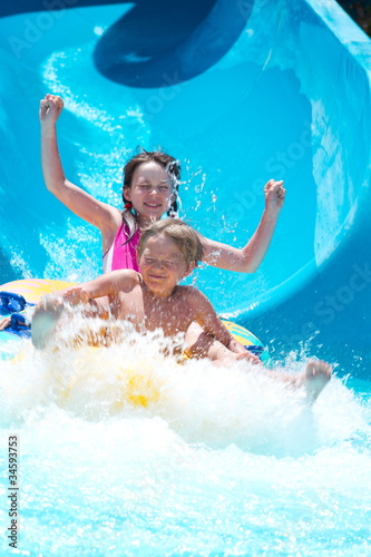 Photo: Kids playing on water slide Kids playing on water slide