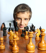 Photo: smiling young boy across the chessboard smiling young boy across the chessboard