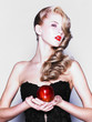 Foto: Young pretty woman in a fashionable dress with apple Young pretty woman in a fashionable dress with apple