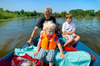 Grandfather with grandchildren on the water