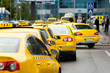 Yellow taxi cabs waiting in front of airport terminal Yellow taxi cabs waiting in front of airport terminal