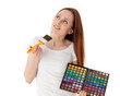 Young woman with cosmetic palette and paintbrush. Young woman with cosmetic palette and paintbrush.