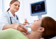 woman getting ultrasound of a thyroid from doctor