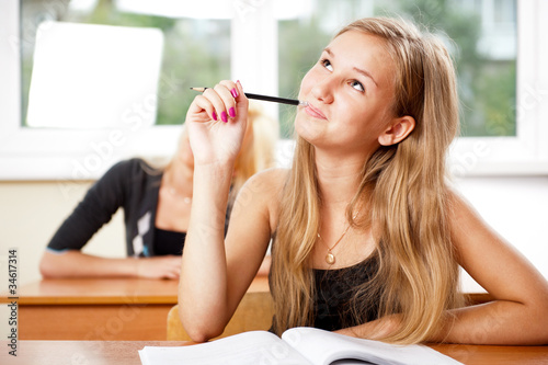 Photo: Portrait of a young group of students paying attention in class. Portrait of a young group of students paying attention in class.