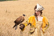 The woman in a beautiful old style dress with falcon has a rest The woman in a beautiful old style dress with falcon has a rest