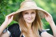 portrait of young woman wearing straw hat