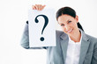 Foto: Business woman holding question mark Business woman holding question mark