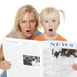Photo: Very surprised mother and daughter reading newspaper together Very surprised mother and daughter reading newspaper together