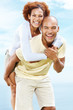 Happy young couple enjoying a piggy back ride