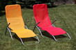 Red and yellow sunbed on grass outdoor