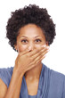 Smiling young woman covering her mouth with hand