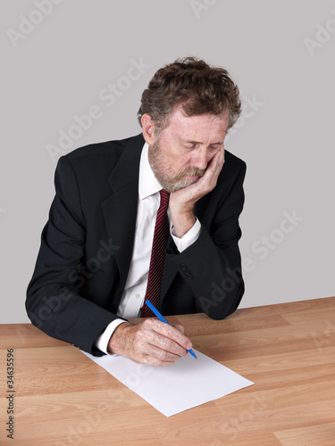Photo: Sad, tired man at desk Sad, tired man at desk