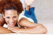 Photo: Smiling woman relaxing on floor Smiling woman relaxing on floor