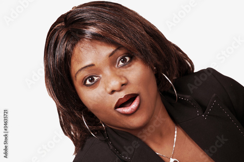 Photo: Surprised african woman with wide eyes and mouth open Surprised african woman with wide eyes and mouth open