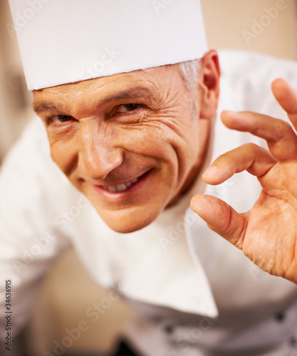 Photo: Smiling chef with positive gesture Smiling chef with positive gesture