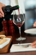 Pouring red wine in cup